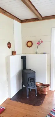 a fireplace in a room with a stove at Irenegarden - Fjord view holiday home in Lauvstad