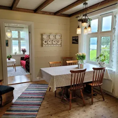 a dining room with a table and chairs at Irenegarden - Fjord view holiday home in Lauvstad