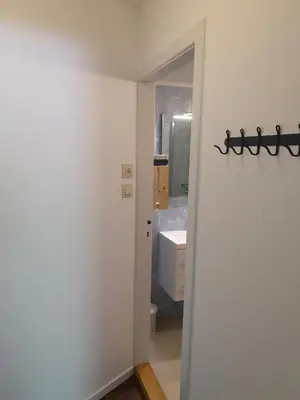 a bathroom with a door leading to a sink at Kvamsdal Pensjonat 4 in Eidfjord