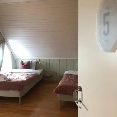 a bedroom with two beds and a window at Villa Sole, Trysil in Trysil