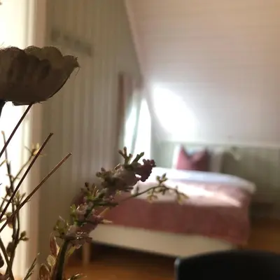 a bedroom with a bed and a vase with a flower at Villa Sole, Trysil in Trysil