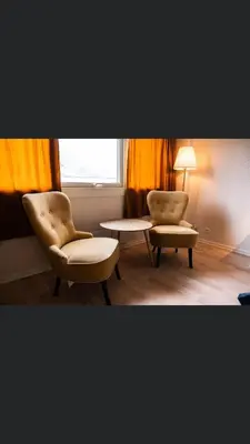 a room with two chairs and a table and a window at Fabel kafé og Motell in Dale