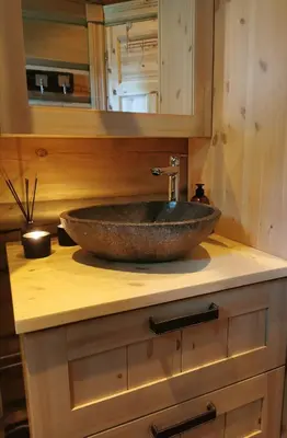a bathroom with a stone sink on a counter at Liaplassen Mountain View in Beitostøl