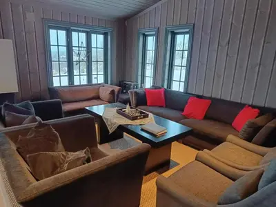 a living room with couches and a coffee table at Mjøshytte in Stange