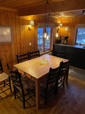 a dining room with a wooden table and chairs at Ski and Bike-In and Out in Hafjell