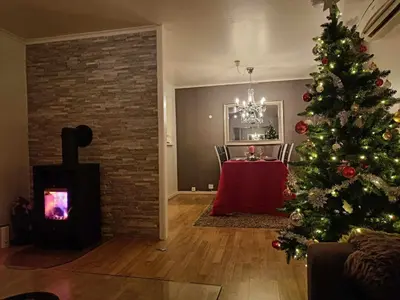 a living room with a christmas tree and a table at Reinebu in Ørsta