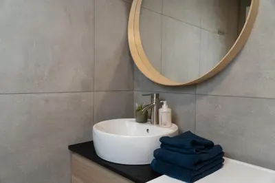 a bathroom with a sink and a mirror at Trolltunga Odda Apartments in Odda