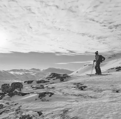 a person on skis standing on a snow covered mountain at Fjellstova Storehorn Apartments in Torset