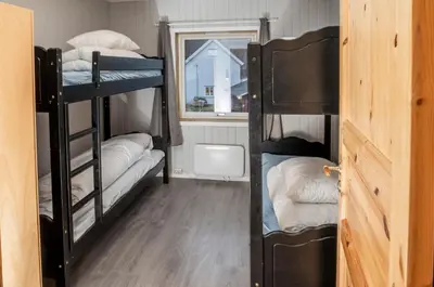 a room with three bunk beds and a window at Lillehammer Camping in Lillehammer