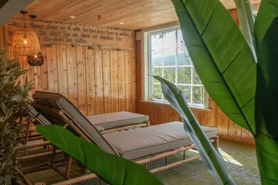 a room with a chair and a window at Pollfoss Boutique Hotel & Spa in Skjåk