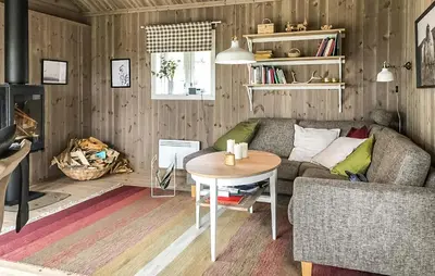 a living room with a couch and a table at Moltebæret in Skåbu