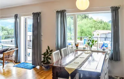 a dining room with a table and a large window at Beautiful Apartment In Årland With Wifi in Hålland