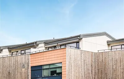 a building with a wooden fence in front of it at Beautiful Apartment In Årland With Wifi in Hålland