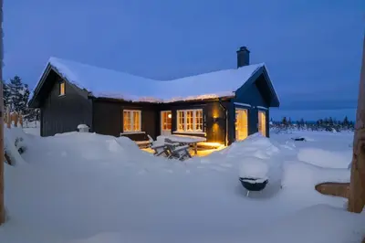 a small house in the snow with snow around it at Villa Budor - 60 min fra OSL - Jaccuzzi - 4 soverom in Nordset
