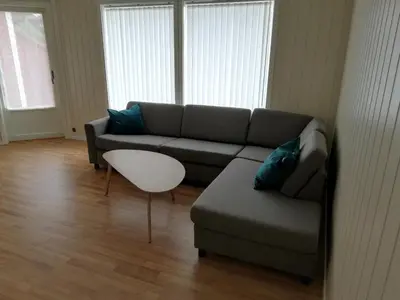 a living room with a couch and a table at Leinastova in Sandshamn