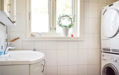 a bathroom with a sink and a washing machine at 3 Bedroom Awesome Home In Skjold in Skjold