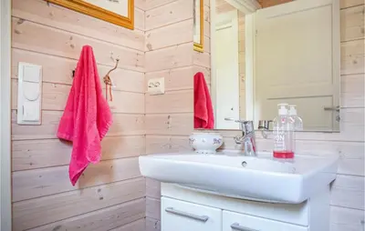 a bathroom with a white sink and a mirror at 3 Bedroom Awesome Home In Skjold in Skjold