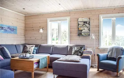 a living room with a blue couch and two chairs at 3 Bedroom Awesome Home In Skjold in Skjold