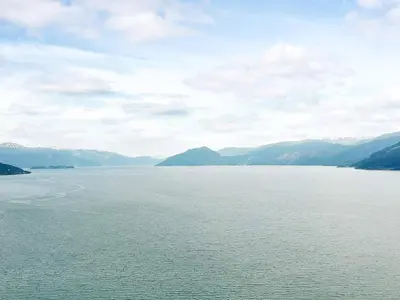 a large body of water with mountains in the background at Seaside Serenity in Hardangerfjord-By Traum in Tyrvikbygd