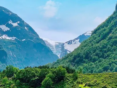 a view of a valley with snow covered mountains at Seaside Serenity in Hardangerfjord-By Traum in Tyrvikbygd