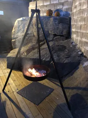 a fire pit with a bowl of food in it at Ramsbu utsikt terasse selvhushold in Hovden