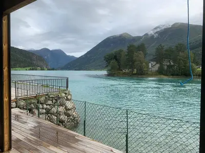 a view of a river with mountains in the background at Stryn Crystal Apartments - Waterfront Apartment in Stryn