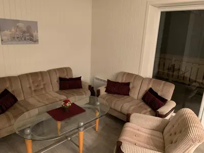 a living room with two couches and a glass table at Stryn Crystal Apartments - Waterfront Apartment in Stryn