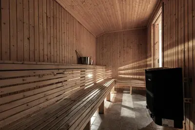 an empty sauna with a bench and a window at Storelia in Hemsedal