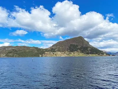 a large body of water with a mountain in the background at 8 person holiday home in Barmen in Barmen