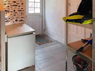 a kitchen with a white refrigerator and a door at 8 person holiday home in Barmen in Barmen