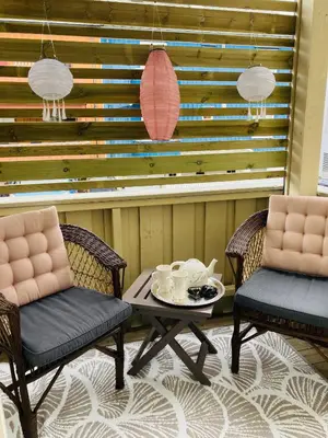 a room with two chairs and a table with cups on it at Apartments At The Sentrum in Kristiansund