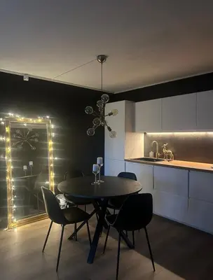 a dining room with a table and chairs in a kitchen at Oppdal Alpintun ski in ski out in Oppdal