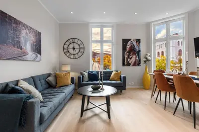 a living room with a blue couch and a table at Keyser Apartments 8 in Bergen
