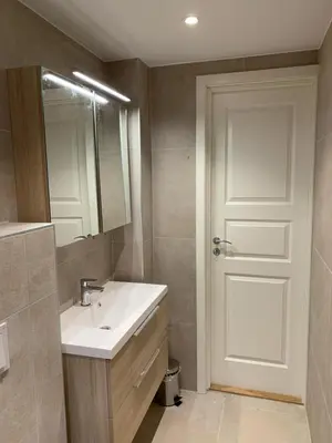 a bathroom with a sink and a mirror and a door at # 1 Mountain View with free street parking in Bergen