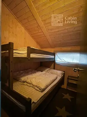 a bunk bed room with two bunk beds in a cabin at Modern sports cabin on Sjusjøen with sauna and waxing room in Ringsaker