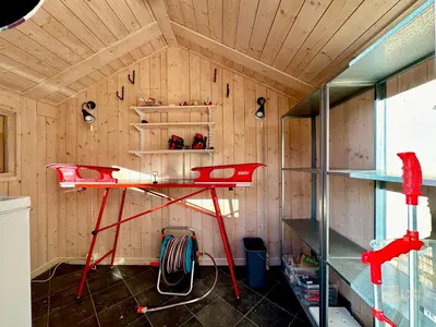 a room with a red desk in a room at Modern sports cabin on Sjusjøen with sauna and waxing room in Ringsaker