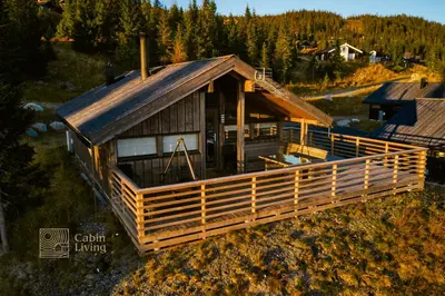 an overhead view of a house with a gambrel roof at Modern sports cabin on Sjusjøen with sauna and waxing room in Ringsaker