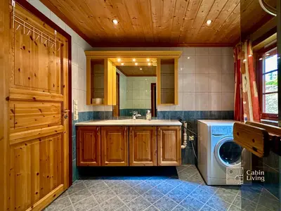 a bathroom with a sink and a washing machine at Large Cottage 2 Baths and Sauna in Sjusjøen in Lillehammer