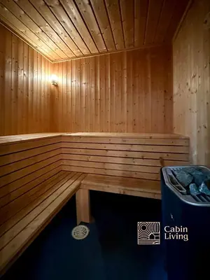 a small wooden sauna with a trash can in it at Large Cottage 2 Baths and Sauna in Sjusjøen in Lillehammer