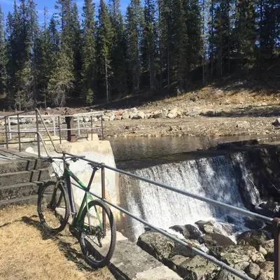 a bike parked on a rail next to a waterfall at Large Cottage 2 Baths and Sauna in Sjusjøen in Lillehammer