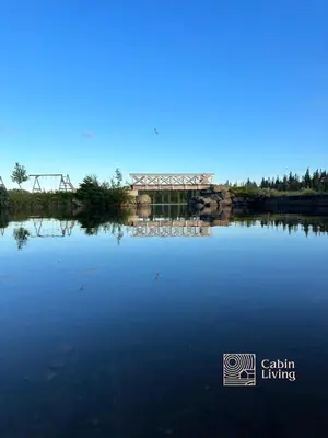 a large body of water with a bridge in the background at Large Cottage 2 Baths and Sauna in Sjusjøen in Lillehammer
