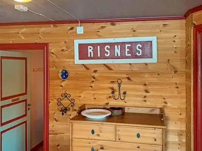 a wooden wall with a sign that reads risses at 6 person holiday home in HOSTELAND in Hosteland
