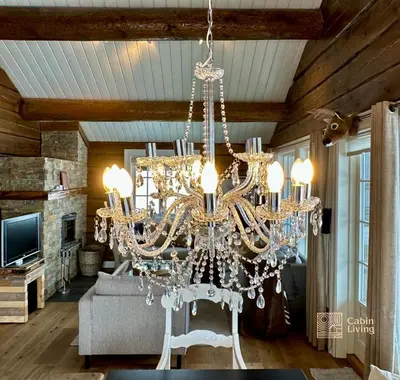 a chandelier hanging from a ceiling in a living room at Large family cabin in Hafjell ski in-out, BBQ, terrace and fireplace in Hafjell