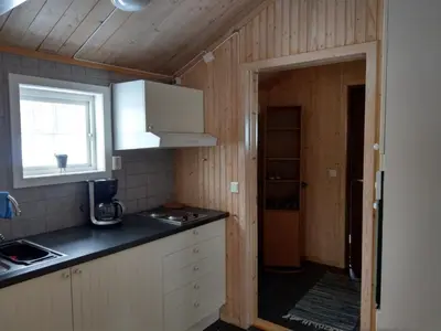 a kitchen with a counter top and a window at Nordpå Fjellhotell AS in Haltdalen