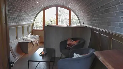 a room with two chairs and a table and a window at Eventyrhyttene i Jotunheimen in Stuttgongfossen