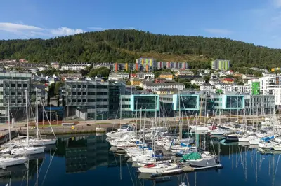 a group of boats are docked in a harbor at Moxy Bergen in Bergen