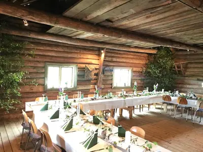 a large room with tables and chairs in it at Drengstua på Dahl Østre in Stange