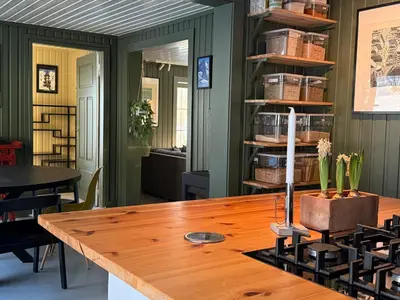a dining room with a wooden table and chairs at Nordre Fossheim Gård Hemsedal in Hemsedal