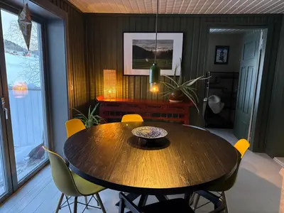 a dining room with a wooden table and chairs at Nordre Fossheim Gård Hemsedal in Hemsedal