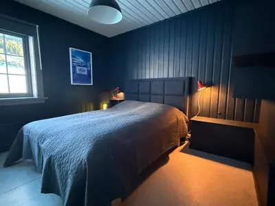 a bedroom with a large bed and a window at Nordre Fossheim Gård Hemsedal in Hemsedal